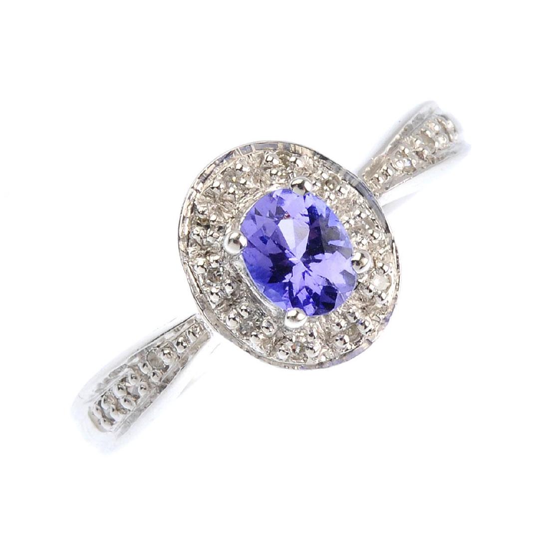 A 9ct gold tanzanite and diamond cluster ring. The (1 of 3)