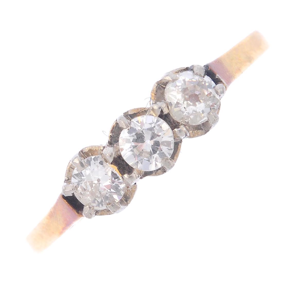 A diamond three-stone ring. The old-cut diamond line, (1 of 3)