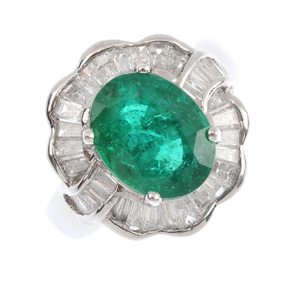 An 18ct gold emerald and diamond cluster ring. The (1 of 4)