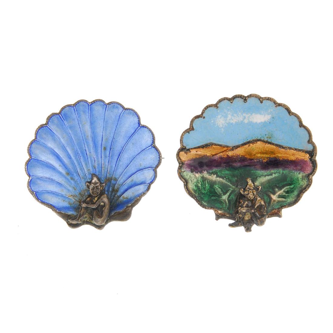 BERNARD INSTONE (attributed to) - two enamel brooches.: BERNARD INSTONE (attributed to) - two enamel brooches. Both designed as pixies, in a seated position, the first to a blue shell background, the second with a cloisonne vari-colour enamel landscape beh