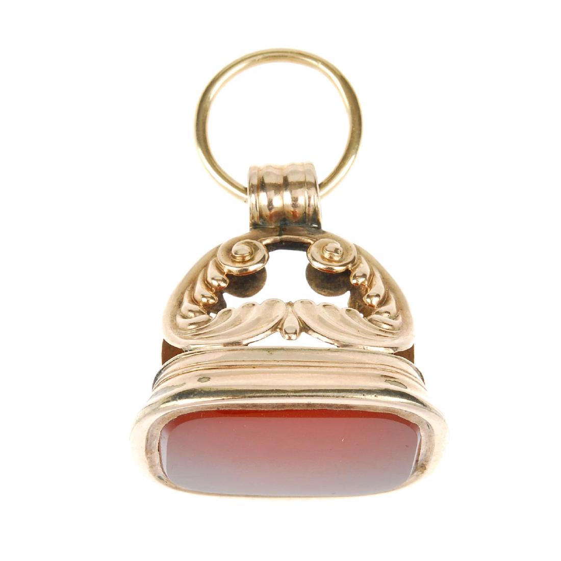 A 9ct gold carnelian fob. The rectangular carnelian: A 9ct gold carnelian fob. The rectangular carnelian panel to the acanthus leaf pedestal and plain surmount loop. Hallmark for Birmingham, 1966. Length 4.9cms. Weight 25gms.