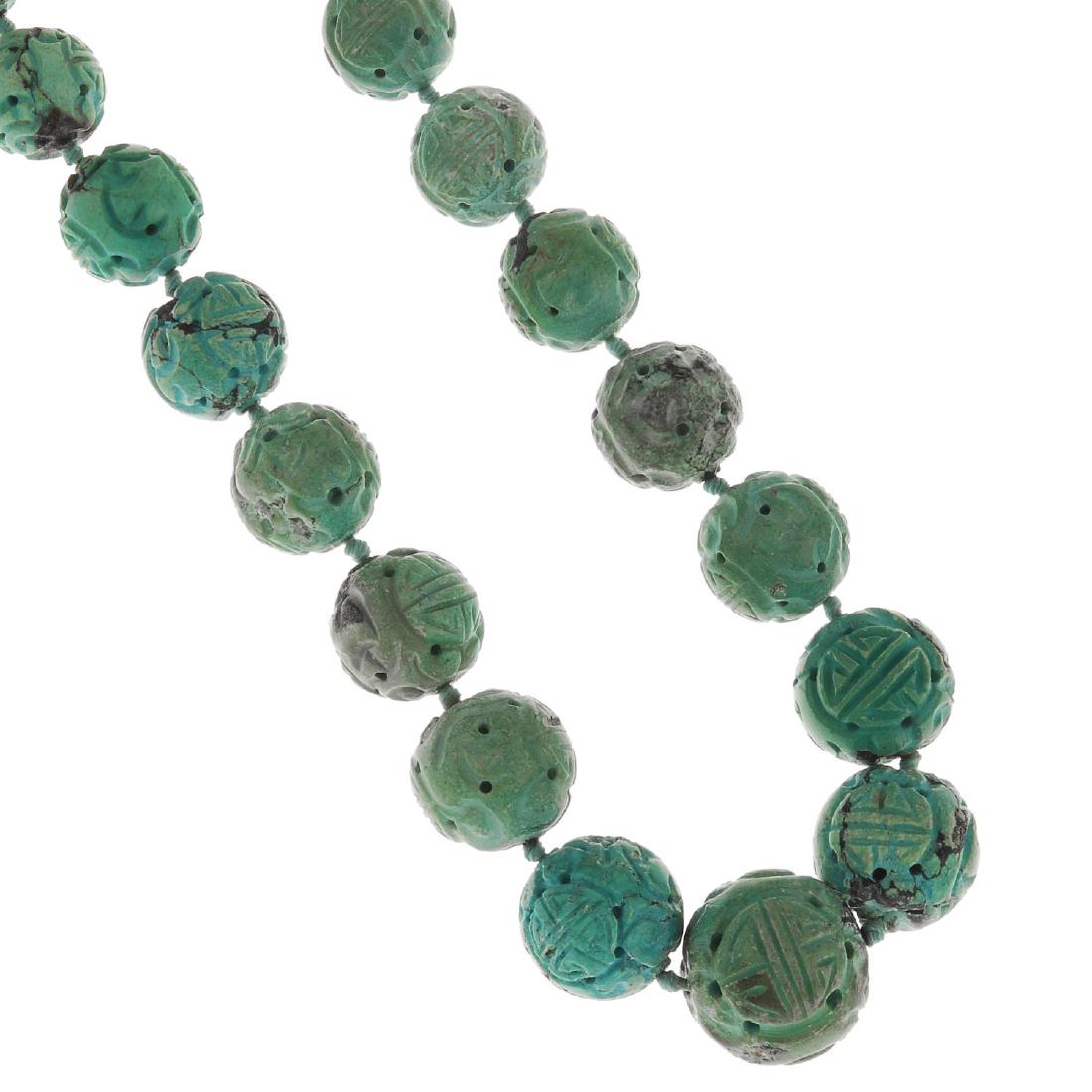 A Chinese Shou carved turquoise bead necklace. (1 of 3)
