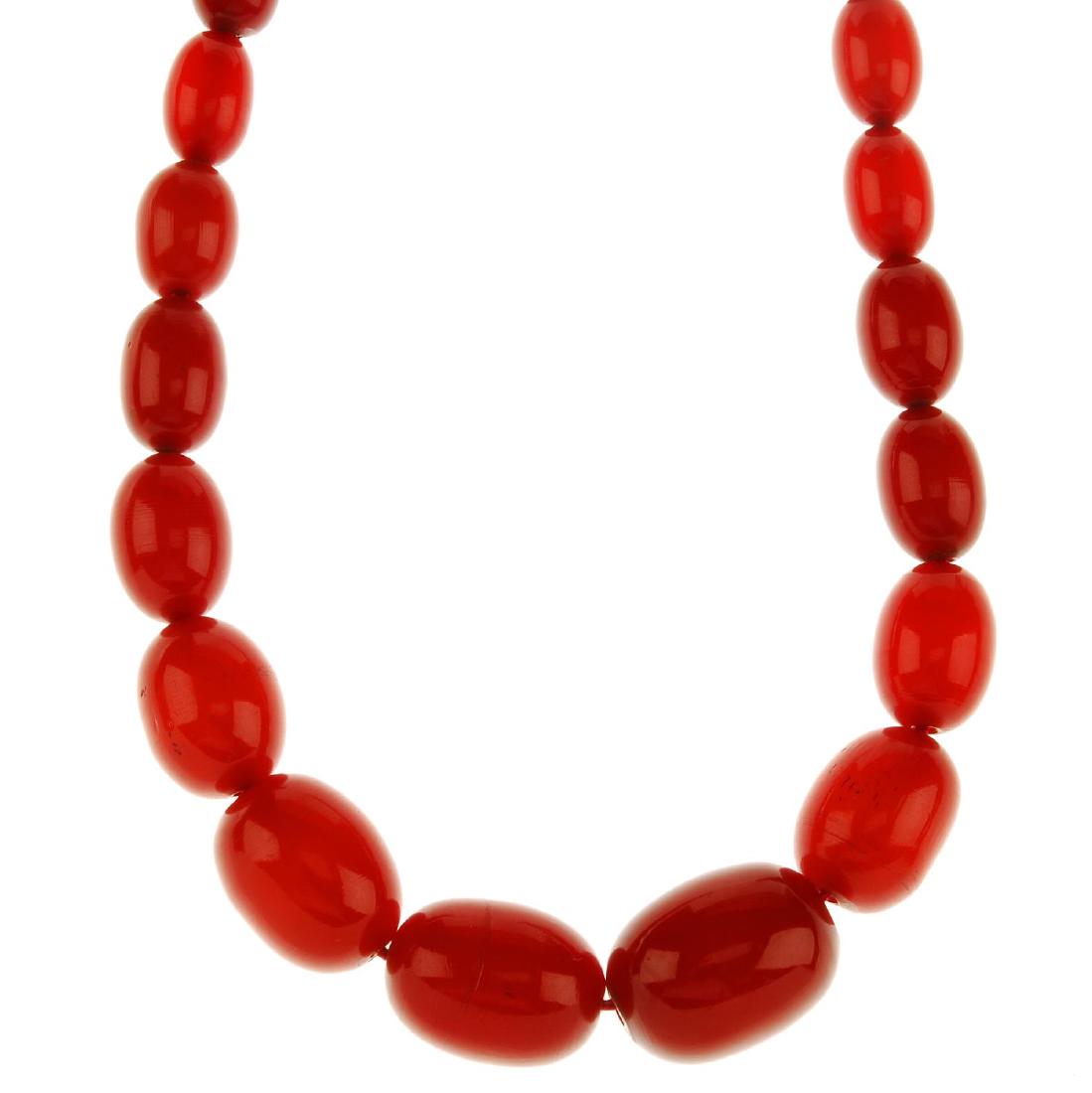 A red plastic bead necklace. Designed as a graduated (1 of 3)