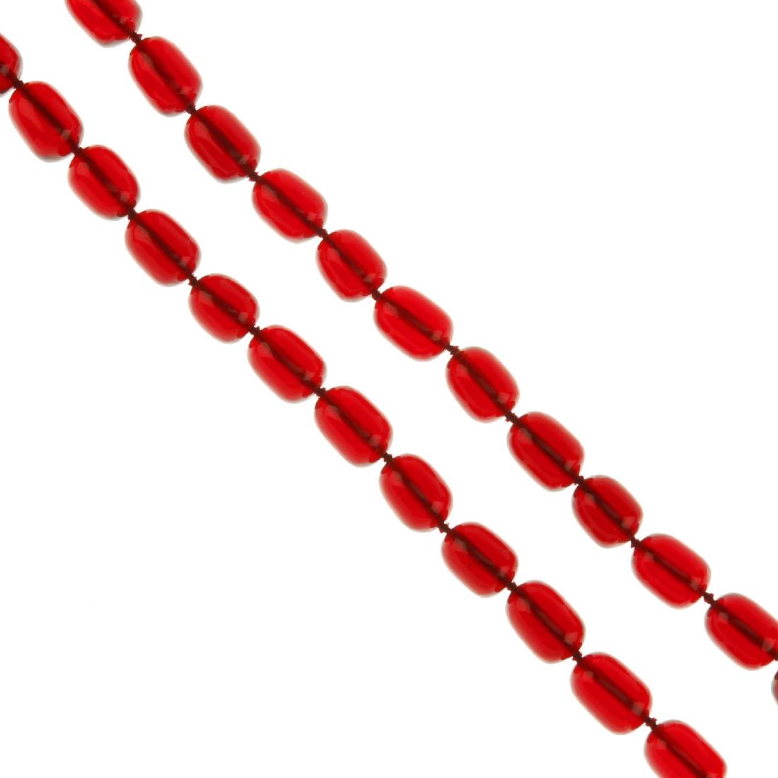 A red plastic bead necklace. The single row of (1 of 2)