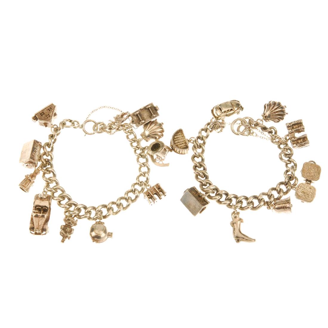 Two silver charm bracelets. Both with heavy curb-link: Two silver charm bracelets. Both with heavy curb-link chains, suspending between them twenty charms, including a shell hinging open to reveal a mermaid within, a rum bottle hinging open to reveal an e