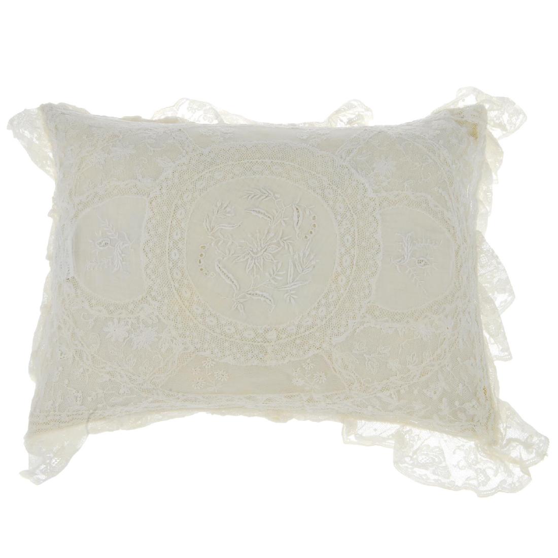 Four items of lace. To include two baby outfits, a lace: Four items of lace. To include two baby outfits, a lace pillow with a floral lace design and a lace single bed sheet.