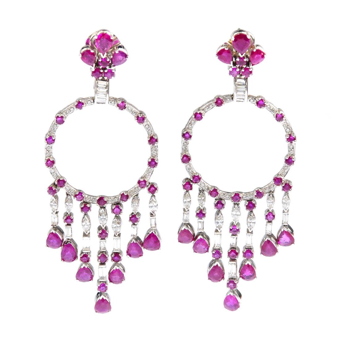 A pair of ruby and diamond earrings. Each designed as a (1 of 2)