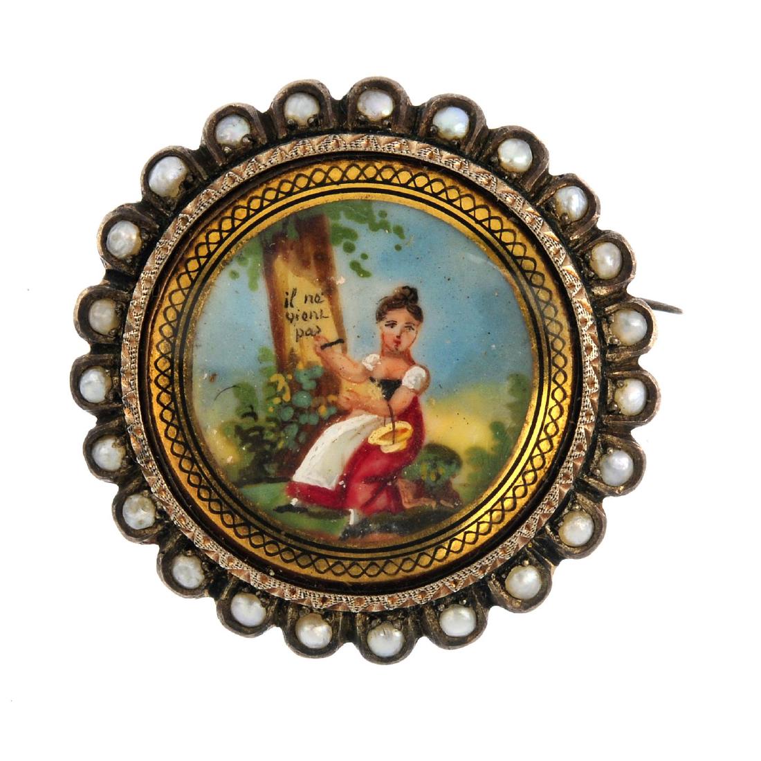 An early 20th century continental brooch. Depicting a: An early 20th century continental brooch. Depicting a lady painting a tree with the inscription, 'il ne vient pas', within a split pearl scalloped surround and glazed panel reverse. Diameter 3.2cms. W