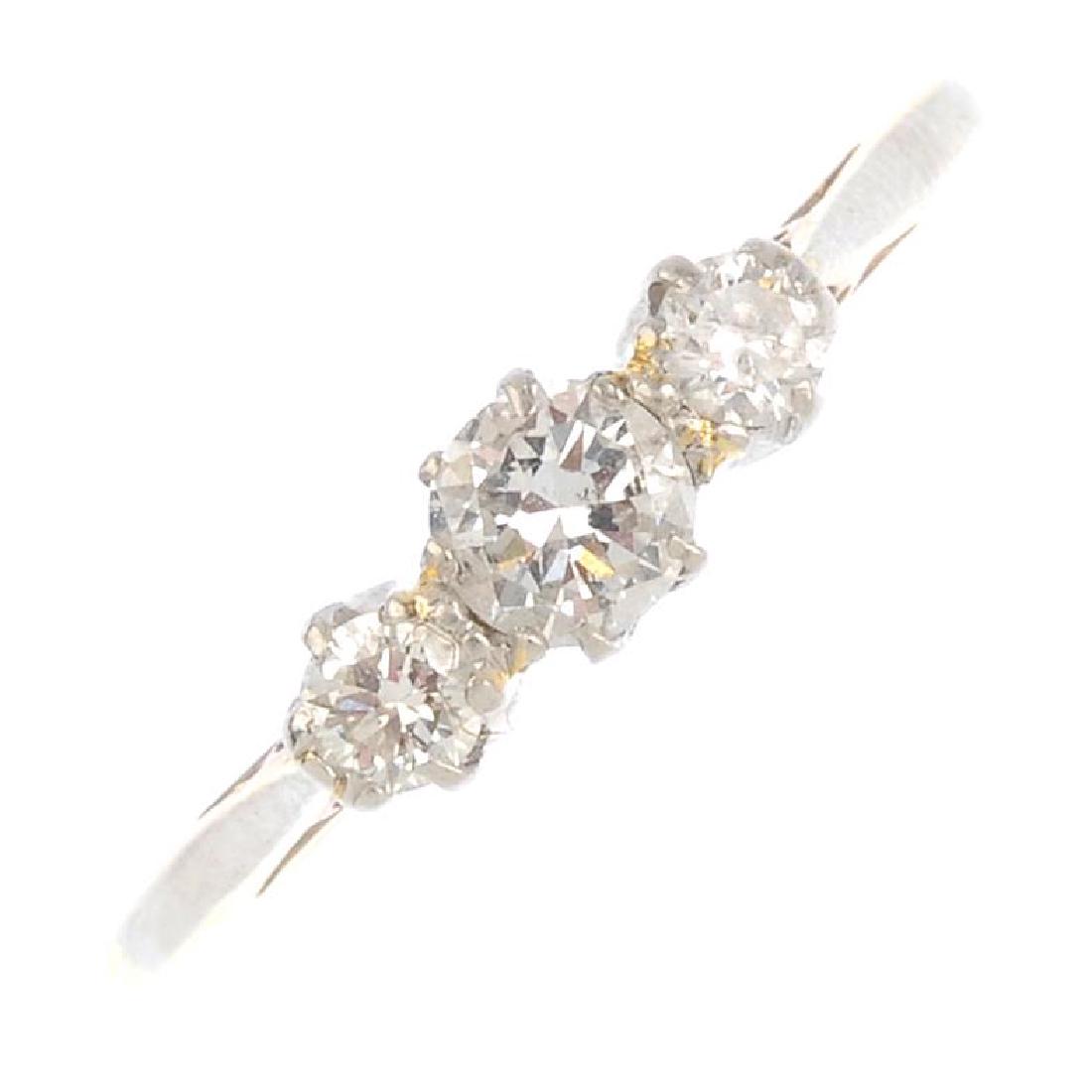 An 18ct gold and platinum diamond three-stone ring. The (1 of 3)