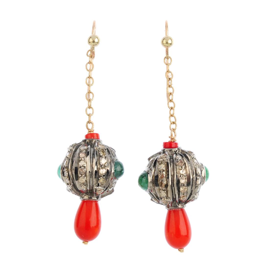 A gem-set ring and pair of earrings. The ring designed (1 of 3)