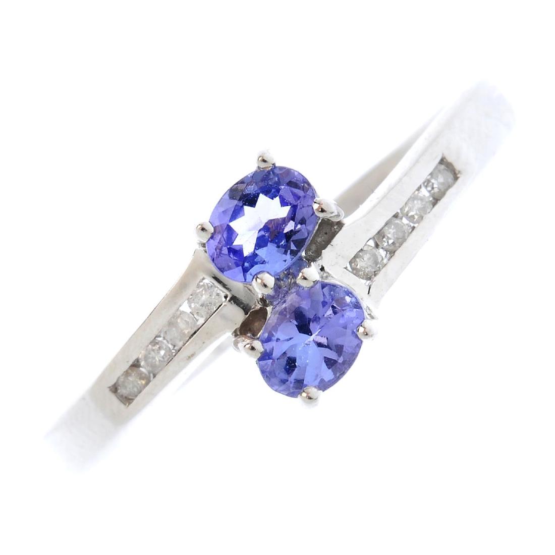 A 9ct gold tanzanite and diamond crossover ring. The (1 of 3)