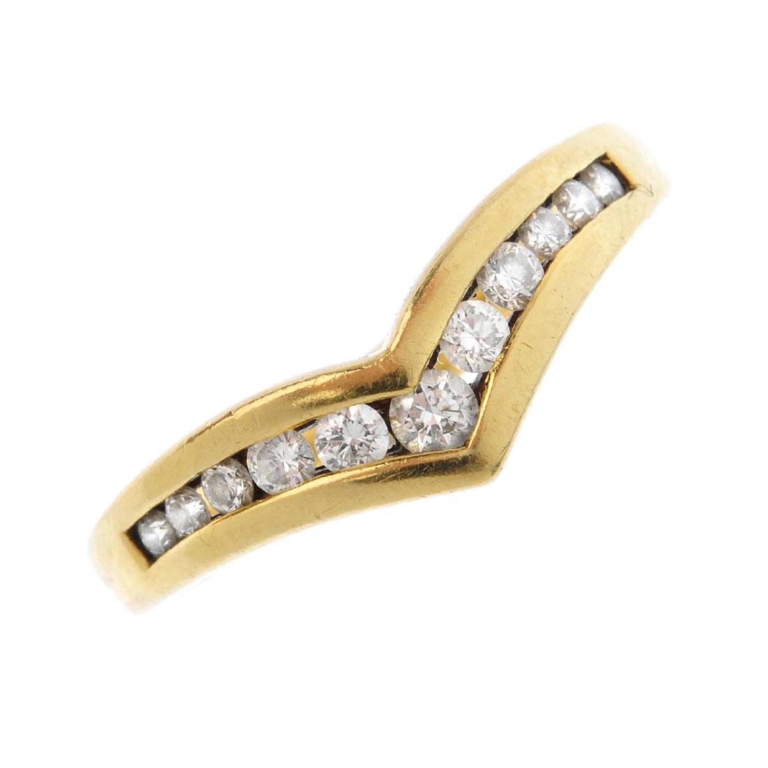 An 18ct gold diamond ring. Designed as a graduated (1 of 3)