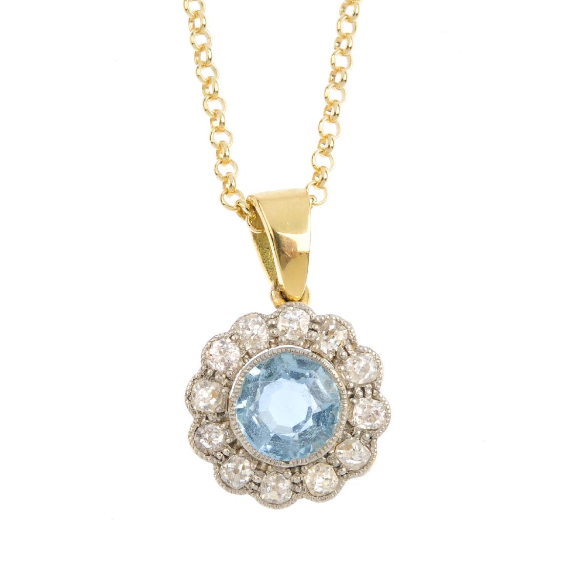 A 14ct gold aquamarine and diamond pendant. The (1 of 3)