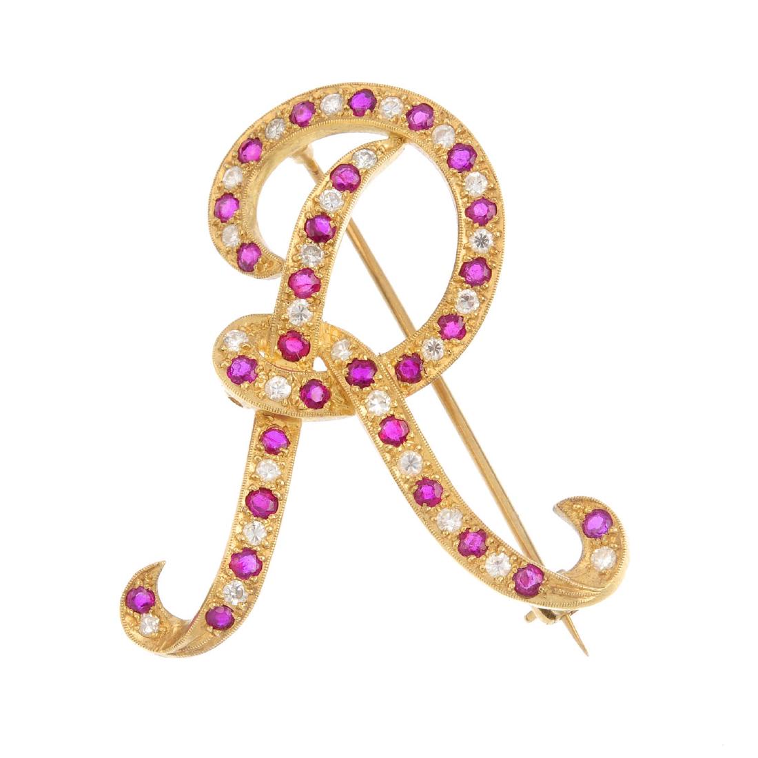 A diamond and ruby brooch. Designed as the letter 'R', (1 of 2)