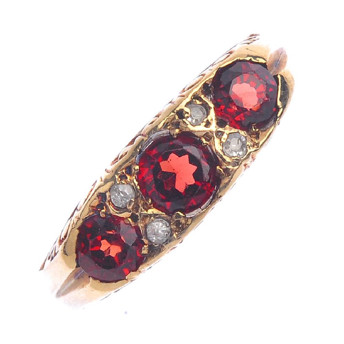 A 9ct gold garnet and diamond ring. The graduated (1 of 2)
