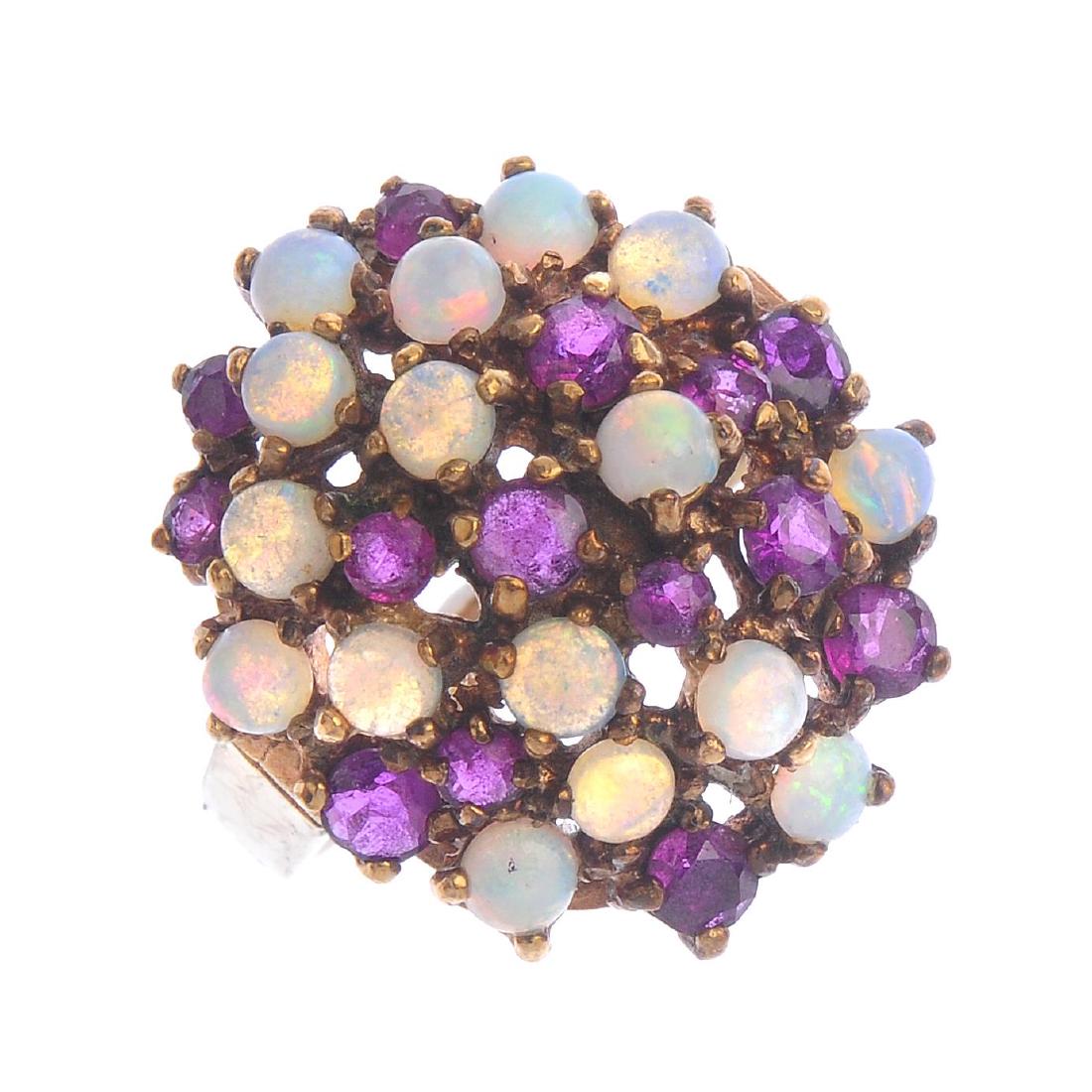 A 9ct gold ruby and opal dress ring. Designed as a (1 of 3)