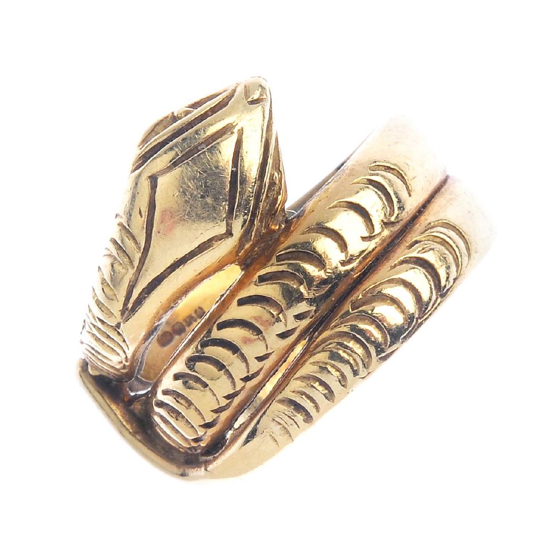 A 9ct gold ring. Designed as a coiled snake, with (1 of 3)