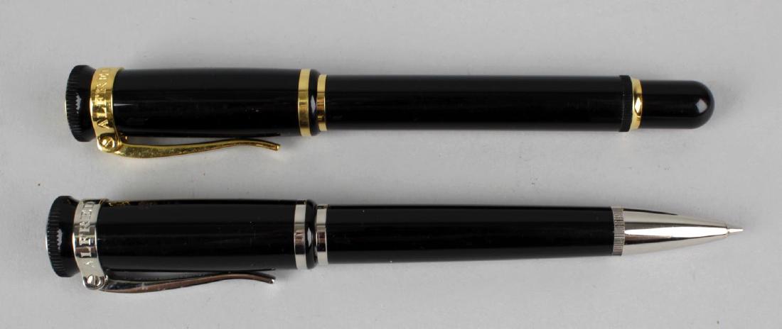 A Dunhill Sentryman ballpoint pen, the black resin body: A Dunhill Sentryman ballpoint pen, the black resin body with gold coloured clip and band, 5.5 (14cm) long, together with a similar Dunhill Sentryman propelling pencil, with silver coloured clip and ba