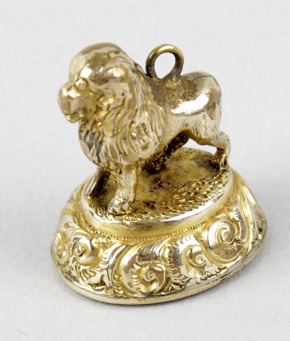 A 19th century gilt metal and carnelian armorial fob: A 19th century gilt metal and carnelian armorial fob seal. Modelled as a standing lion, the oval matrix with intaglio crest of a wild boar with banner motto FIDELISSIMUS SEMPER (Always Faithful), poss