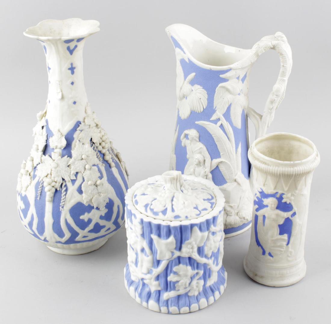 A box containing a large collection of Victorian: A box containing a large collection of Victorian relief-moulded white stoneware pottery. Most with blue highlights, to include a Mayers of Longport No. 97 jug, a trunk-form pot and cover, assorted vas