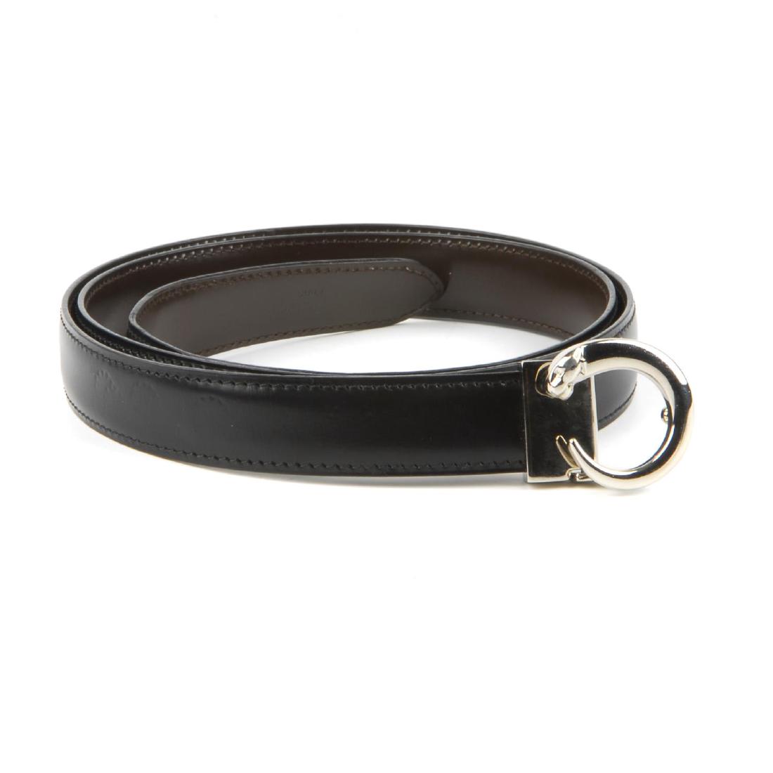 CARTIER - a Panthere belt. The thin black leather belt: CARTIER - a Panthere belt. The thin black leather belt with maker's signature silver-tone panther buckle fastening. Length measures 90cms.