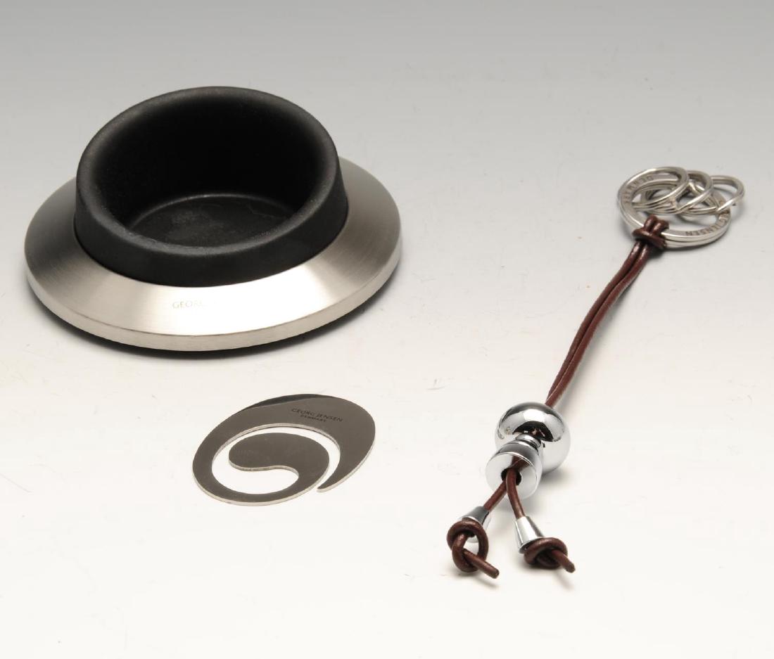 GEORG JENSEN - two Alfredo keyrings, two mobile phone: GEORG JENSEN - two Alfredo keyrings, two mobile phone holders and two money clips. To include two 'Boy' Alfredo keyrings, designed from mirrored stainless steel and leather straps by Alfredo Häberli