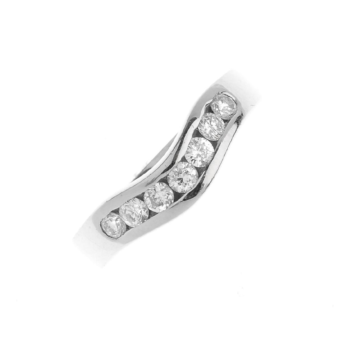 An 18ct gold diamond half eternity ring. The (1 of 3)
