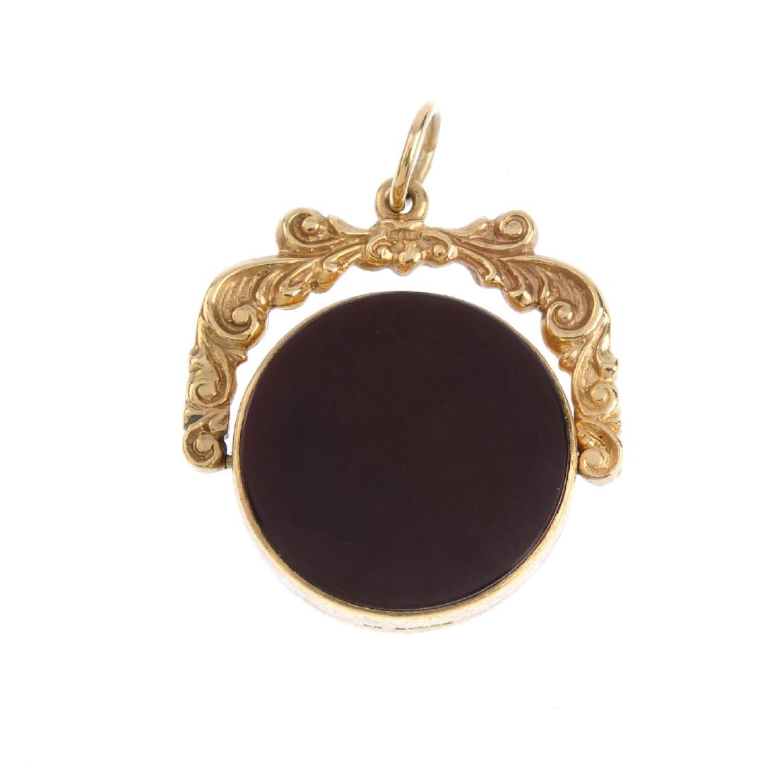 A 1970s 9ct gold hardstone swivel fob. Designed as a (1 of 2)