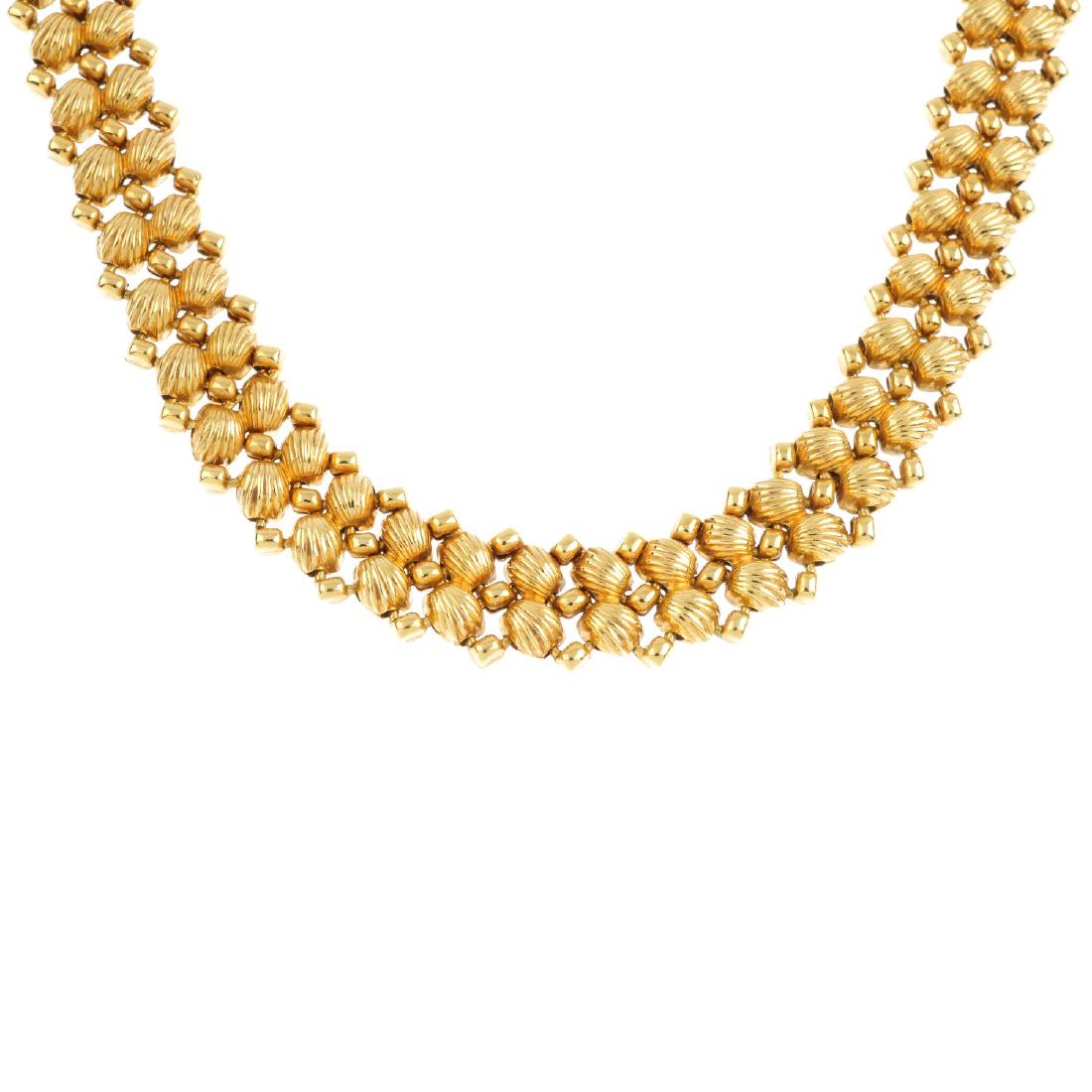 CHIMENTO - an 18ct gold diamond necklace. Comprising: CHIMENTO - an 18ct gold diamond necklace. Comprising two grooved shell motif lines, with bead spacers and brilliant-cut diamond accent clasp. Maker's marks for Chimento. Hallmarks for London, 1999. Le