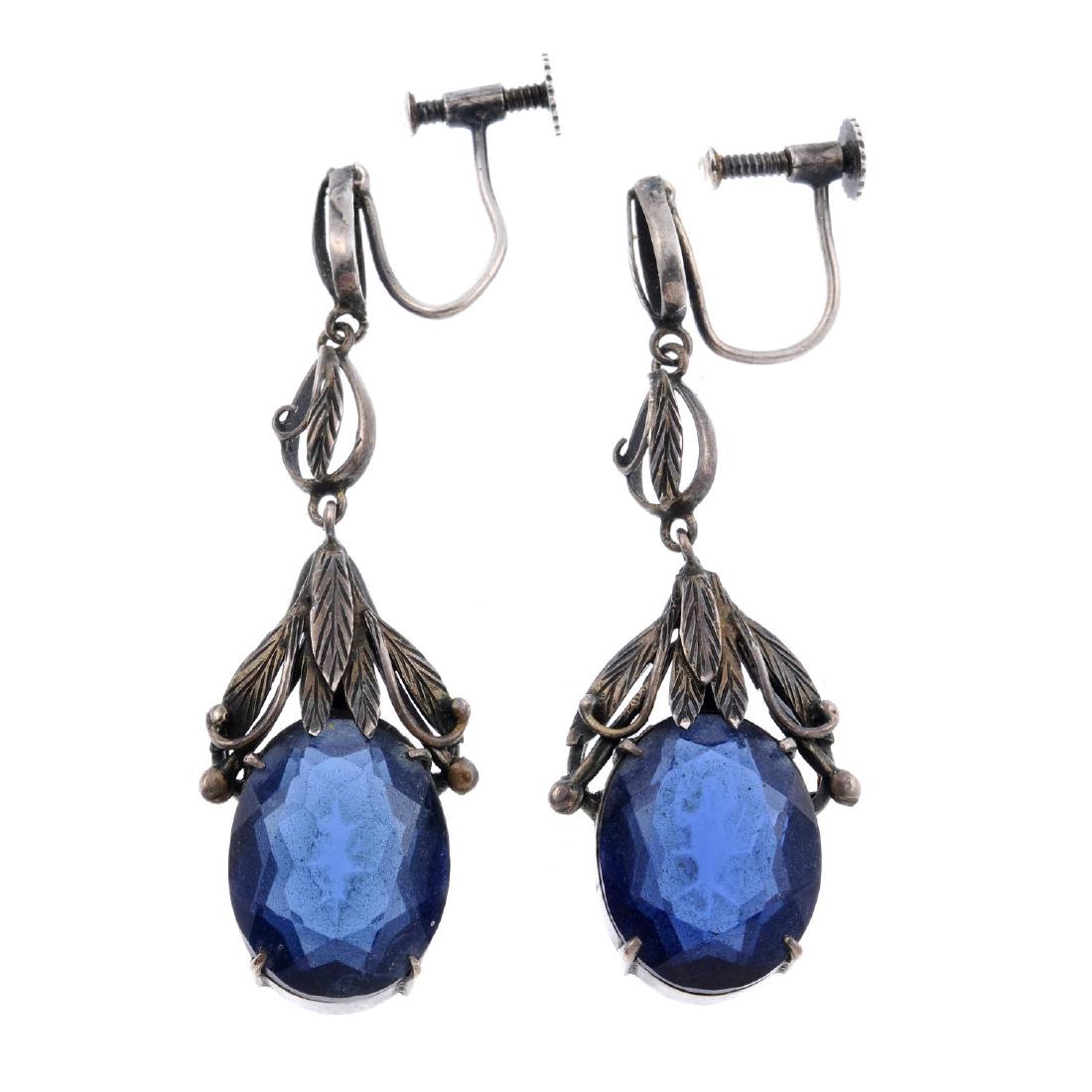 BERNARD INSTONE (attributed to) - a pair of silver blue: BERNARD INSTONE (attributed to) - a pair of silver blue paste earrings. Designed as silver articulated foliate drops, to an overlapping selection of leaves, claw-setting two oval blue pastes. Lengths