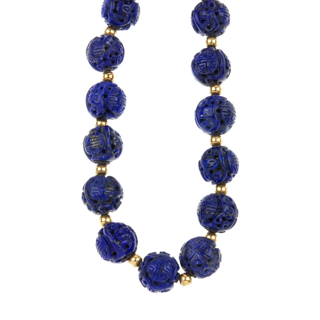 A carved lapis lazuli necklace. Comprising a row of (1 of 3)