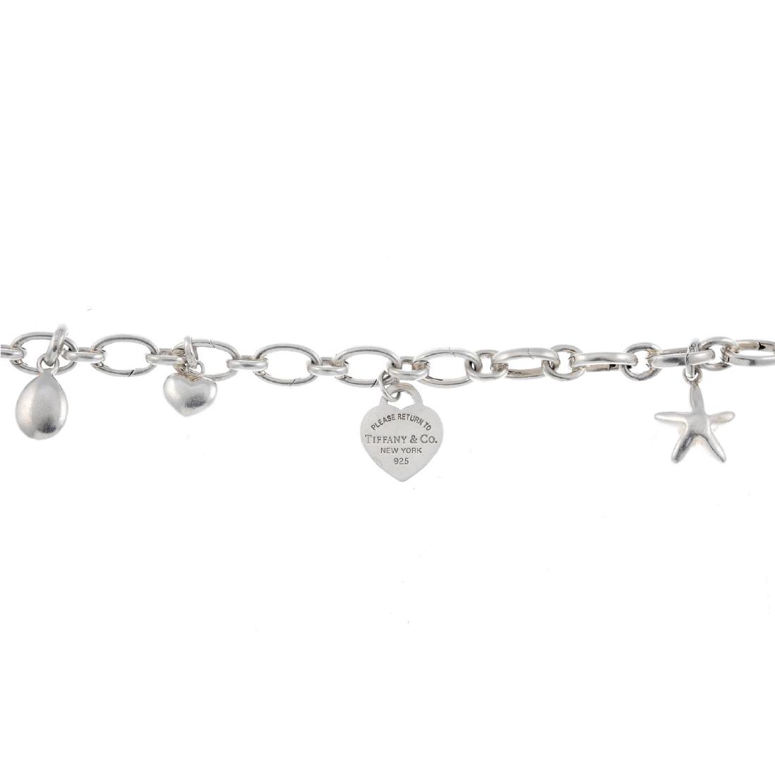 TIFFANY & CO. - a charm bracelet suspending four Links (1 of 3)