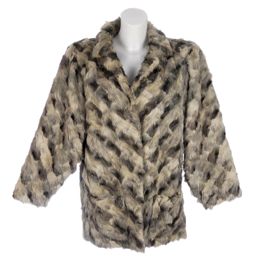 A chevron design pieced pony fur coat. Designed with: A chevron design pieced pony fur coat. Designed with dolman sleeves, a notched lapel collar, hook and eye clip fastenings and two outer pockets. Labelled Fourrures Guy Laroche Paris. Believed to be a