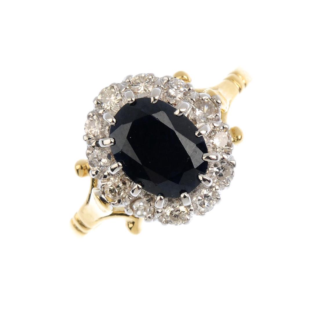 An 18ct gold sapphire and diamond cluster ring. The (1 of 3)