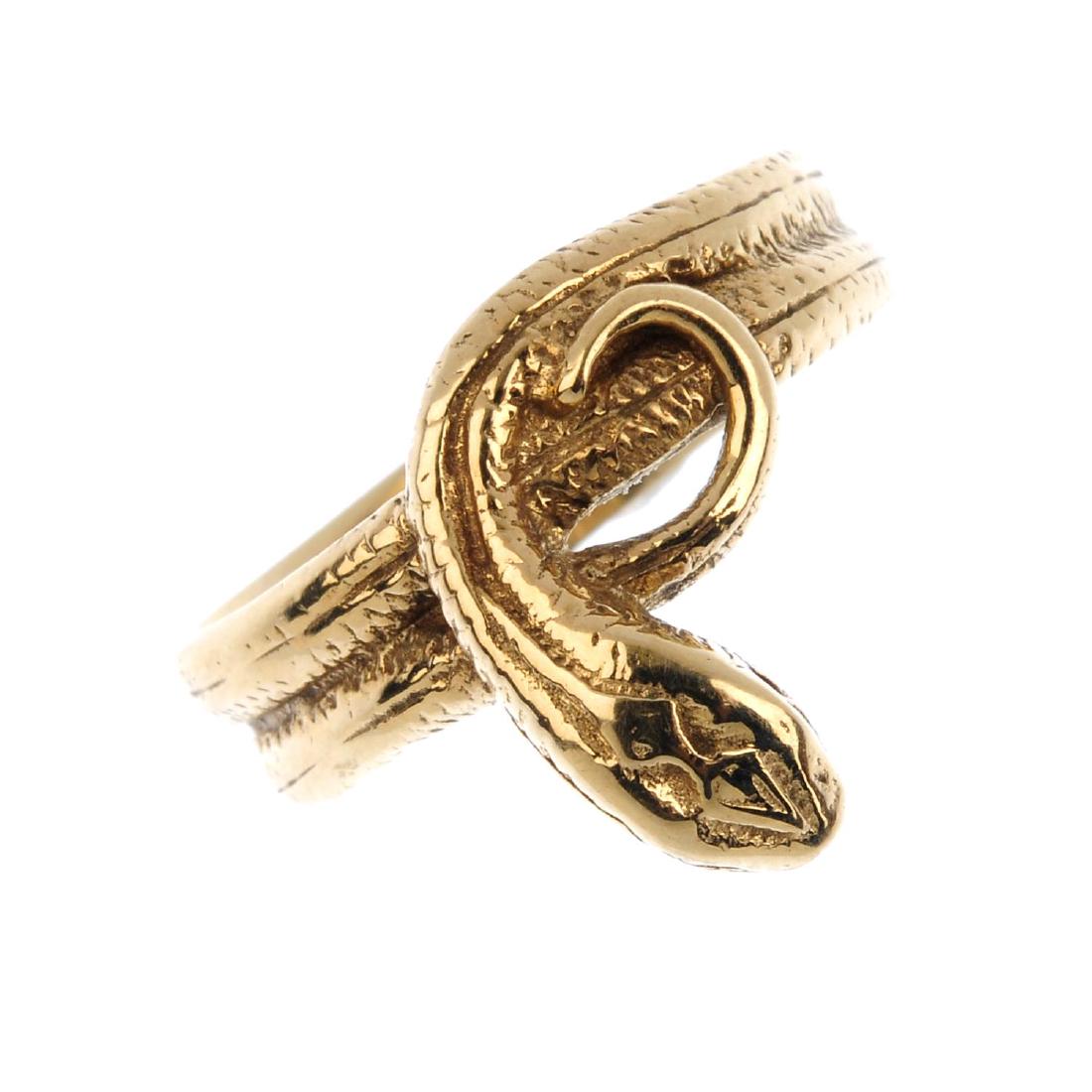 A 9ct gold snake ring. Designed as a coiled snake, with (1 of 3)