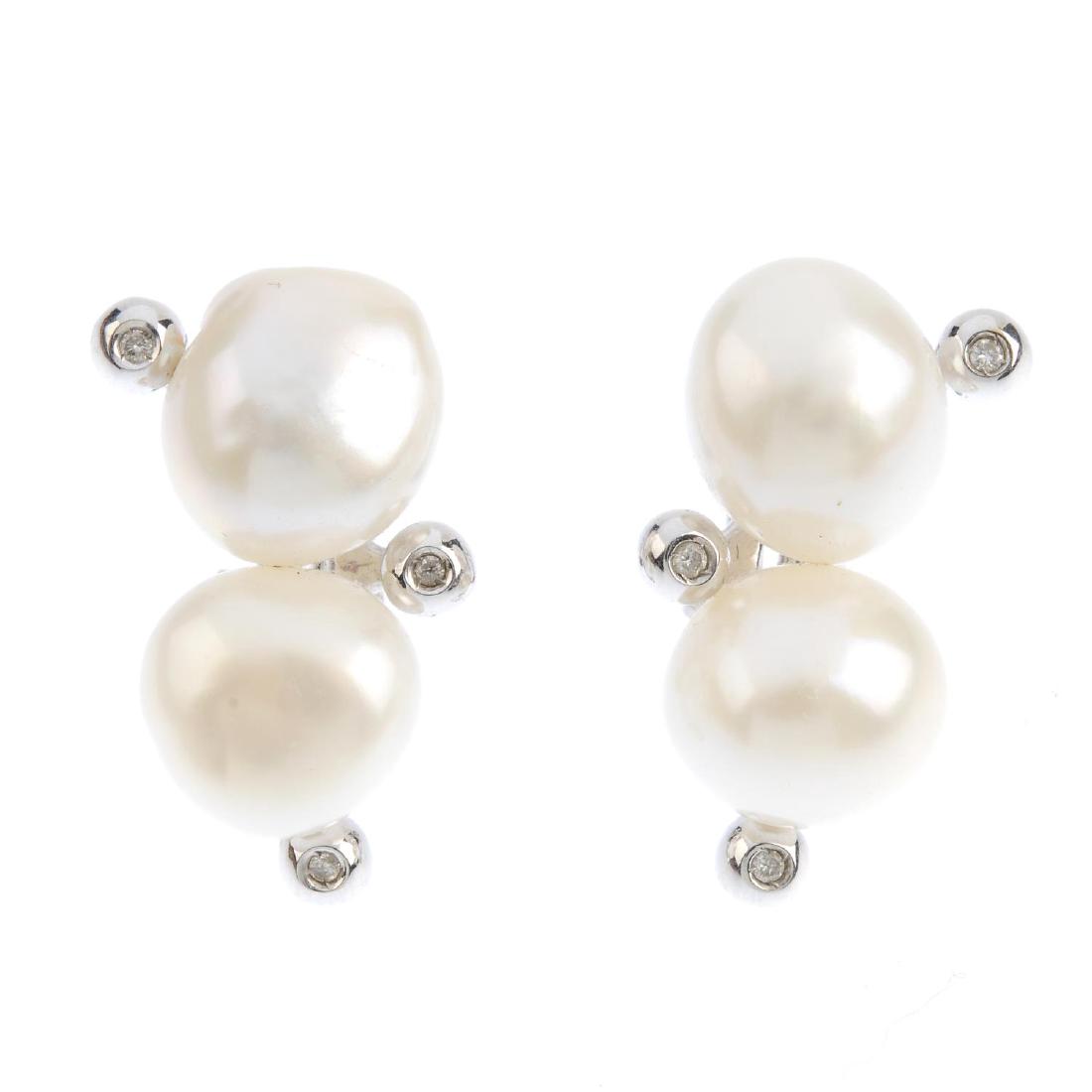 A pair of cultured pearl earrings. Each designed as a: A pair of cultured pearl earrings. Each designed as a cultured pearl line, with brilliant-cut diamond collet accent. Italian marks. Length 2.8cms. Weight 15.1gms.