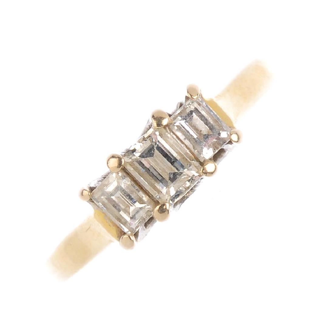 (52273) An 18ct gold diamond three stone ring. The (1 of 2)