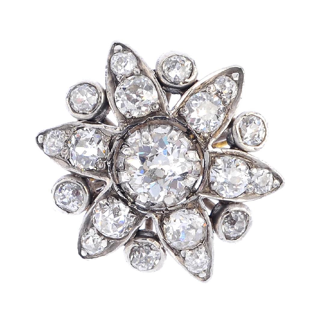 An 18ct gold diamond floral cluster ring. The old-cut (1 of 3)