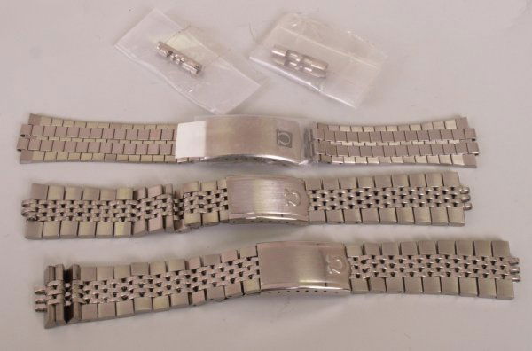 OMEGA - three assorted steel link bracelets of va: OMEGA - three assorted steel link bracelets of varying style each measures 20mm two with lug fittings.