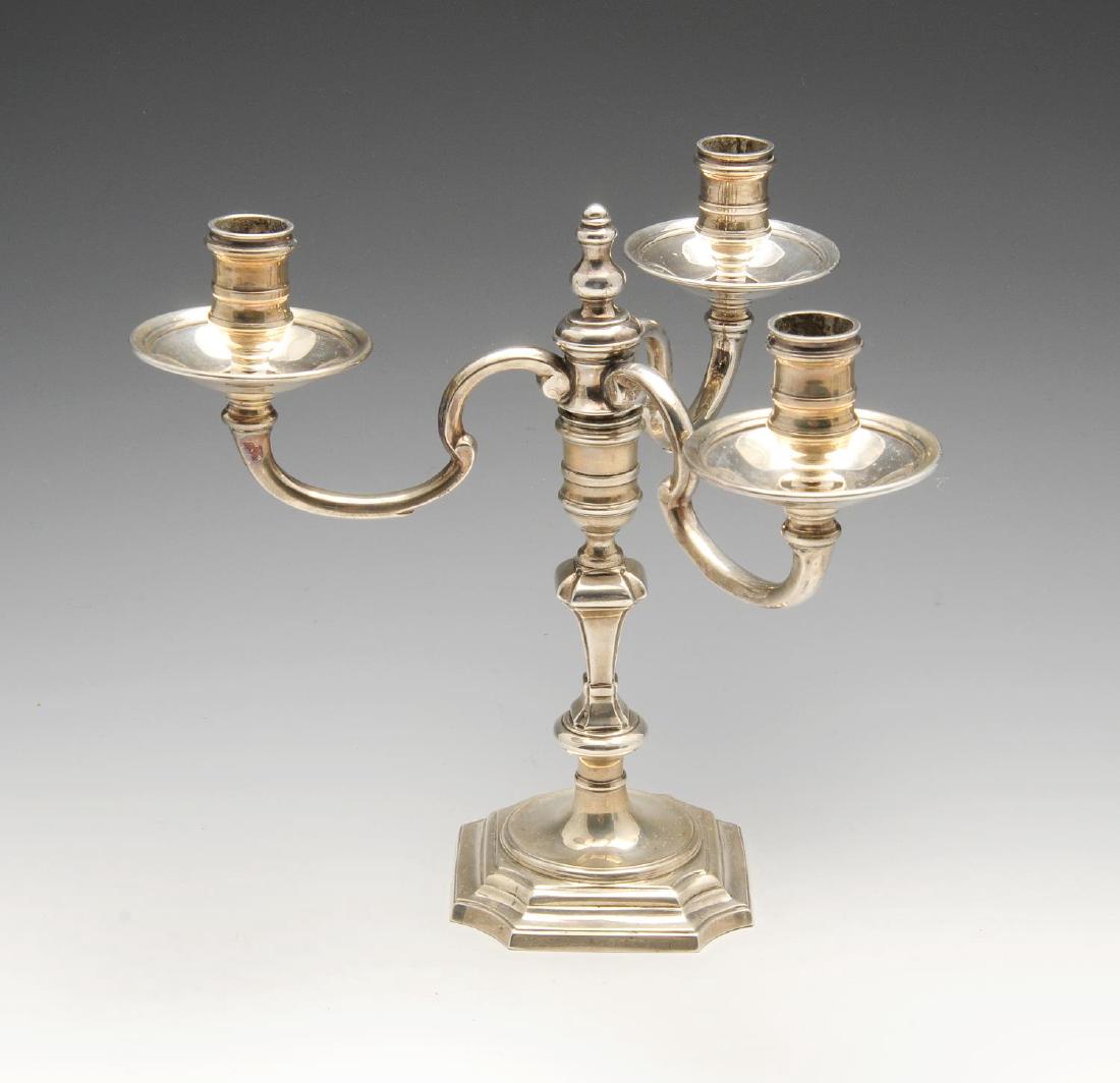 A 1960's silver candelabra, the reeded stepped base: A 1960's silver candelabra, the reeded stepped base leading to a central knopped and tapered stem with a tri-form scrolling detachable branch. Hallmarked J B Chatterley & Sons Ltd., Birmingham 1969, b