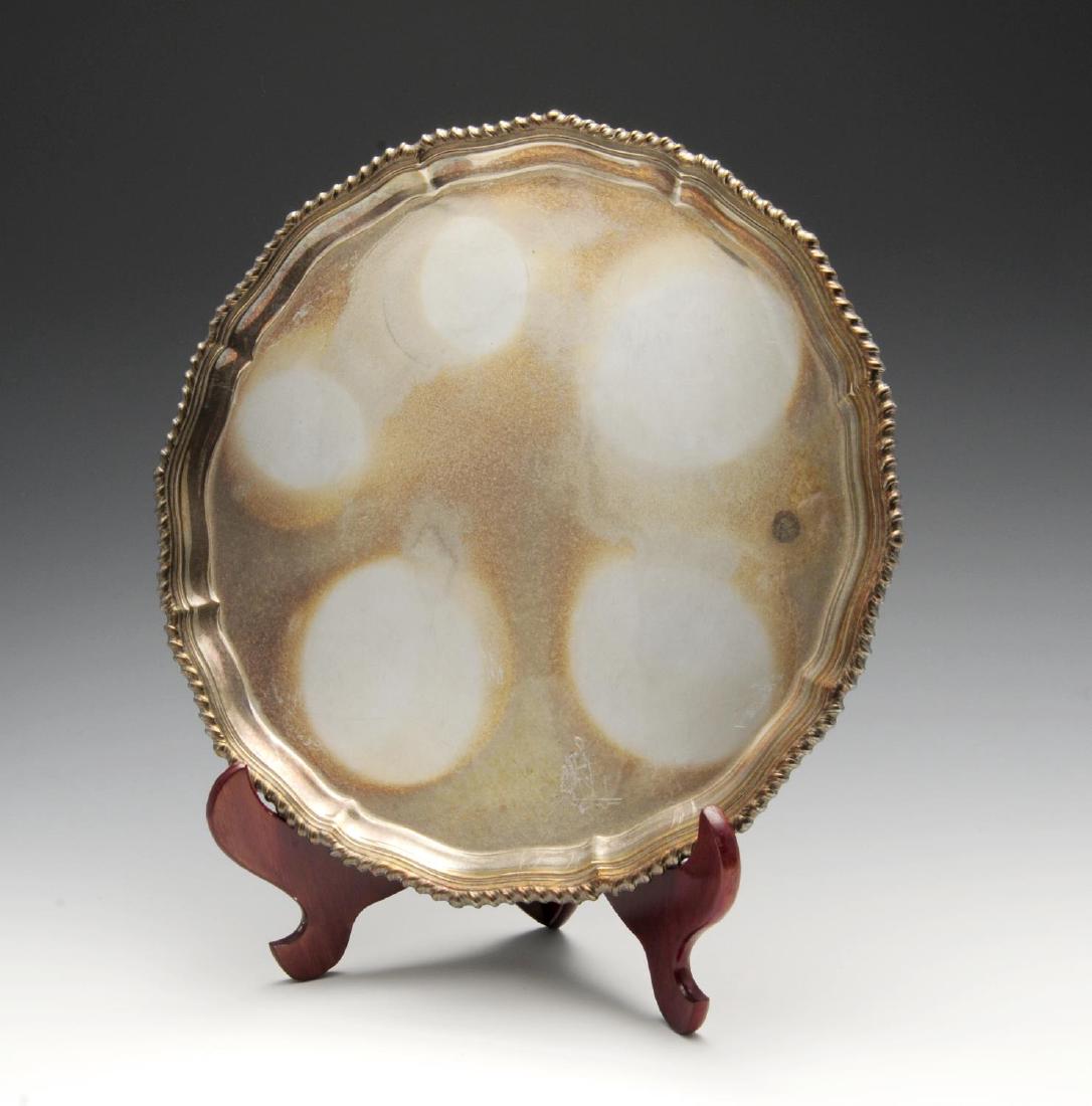 A modern silver salver of circular form, the raised and (1 of 4)