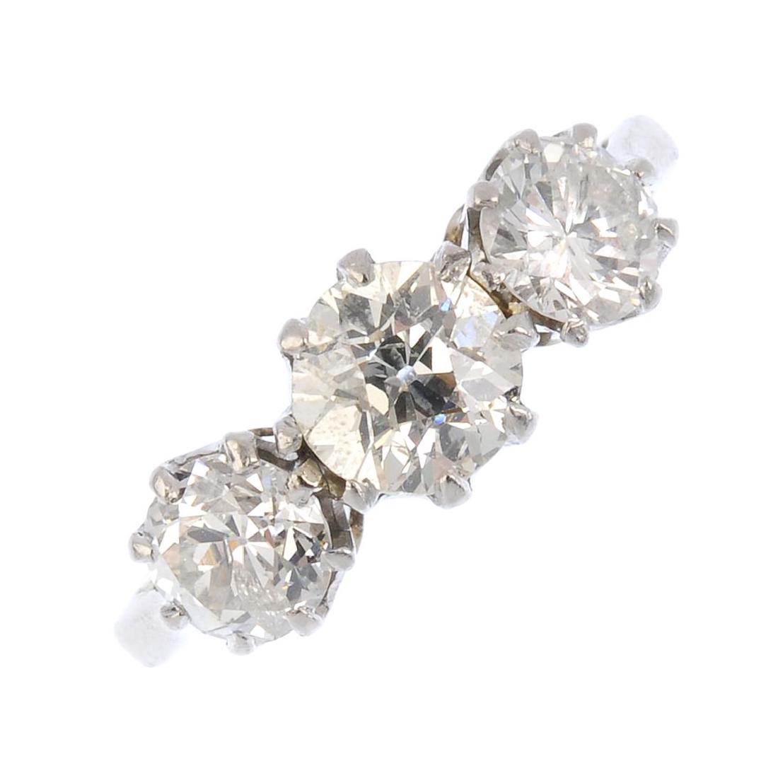 A diamond three-stone ring. Designed as a graduated (1 of 4)