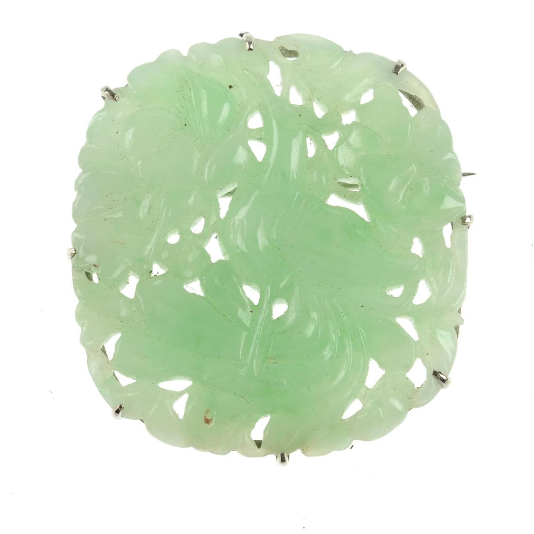 A carved jade brooch. Of cushion shape, the carved (1 of 2)
