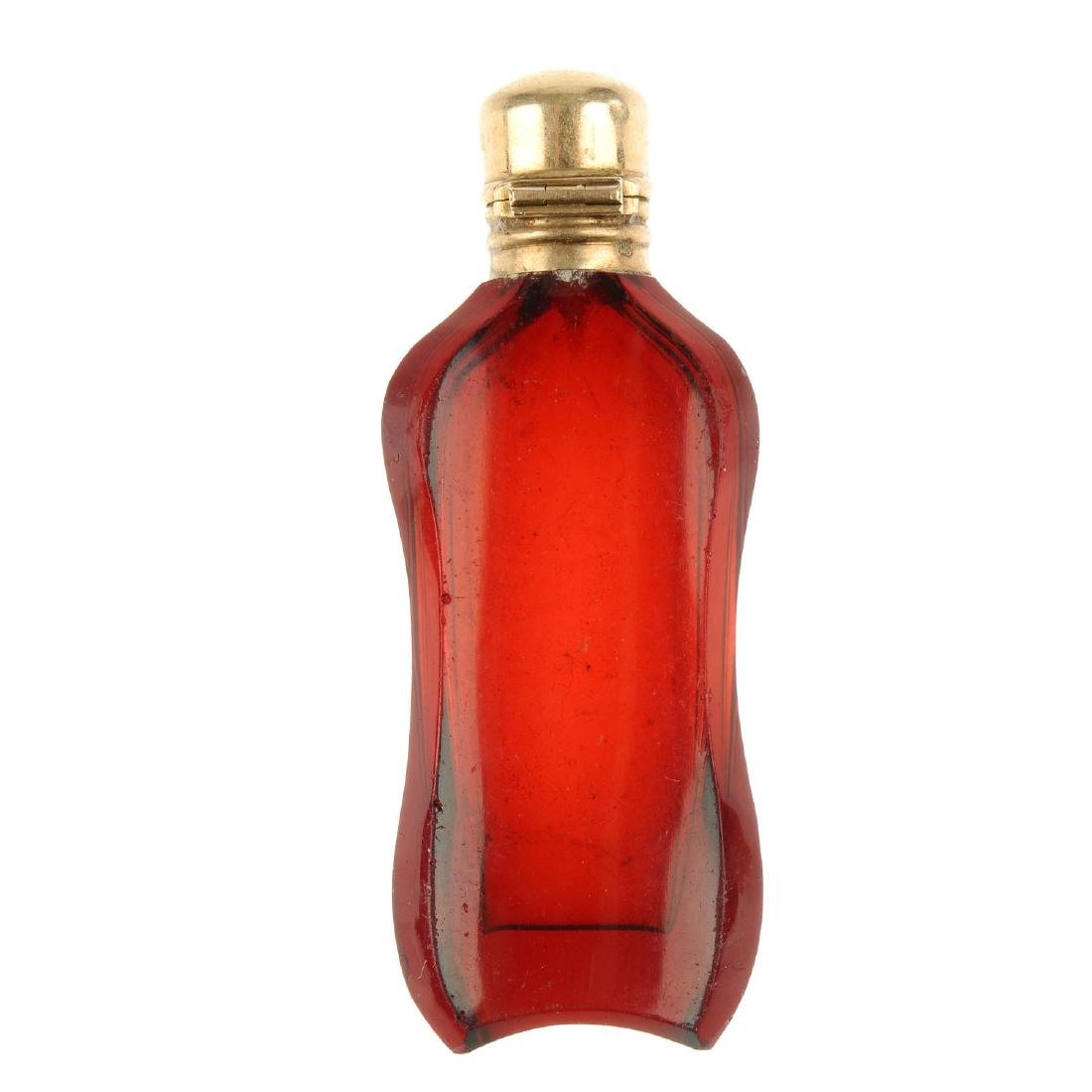 An early 20th century gold topped scent bottle. Of (1 of 3)