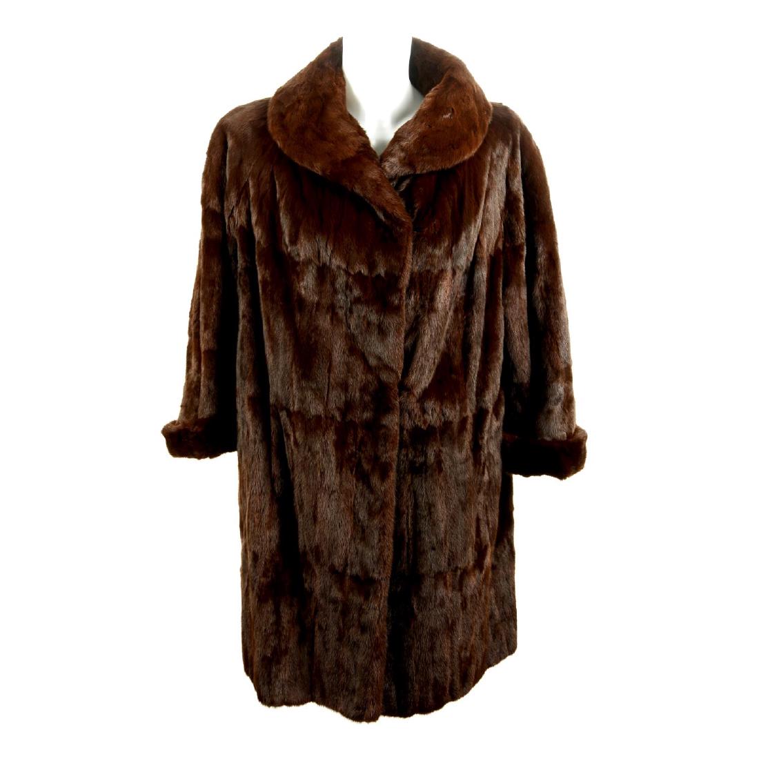 A mink fur stole and a squirrel fur coat. To include a (1 of 3)