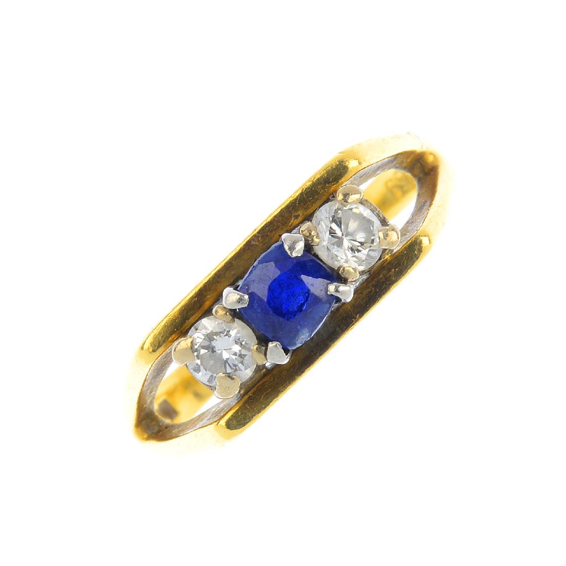An 18ct gold sapphire and diamond three-stone ring. The (1 of 4)