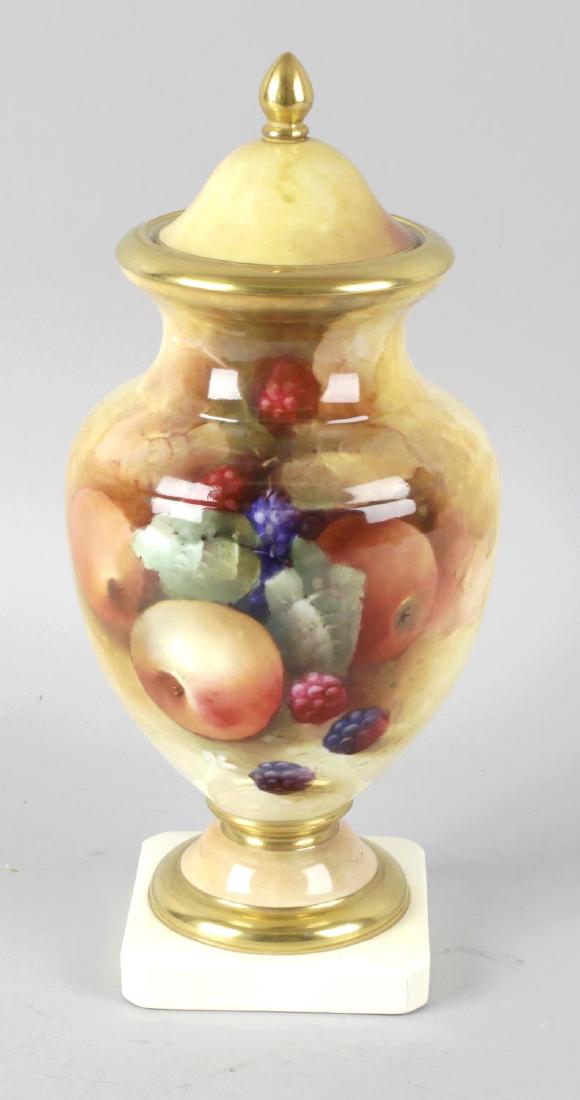 A Royal Worcester style bone china pedestal vase and: A Royal Worcester style bone china pedestal vase and cover, the cream coloured ground hand painted with studies of fruit, marked to base, apples free painted on fine bone china by Roger A Shufflebotha
