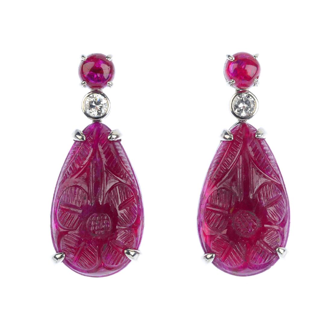 A pair of ruby and diamond earrings. Each designed as a (1 of 2)