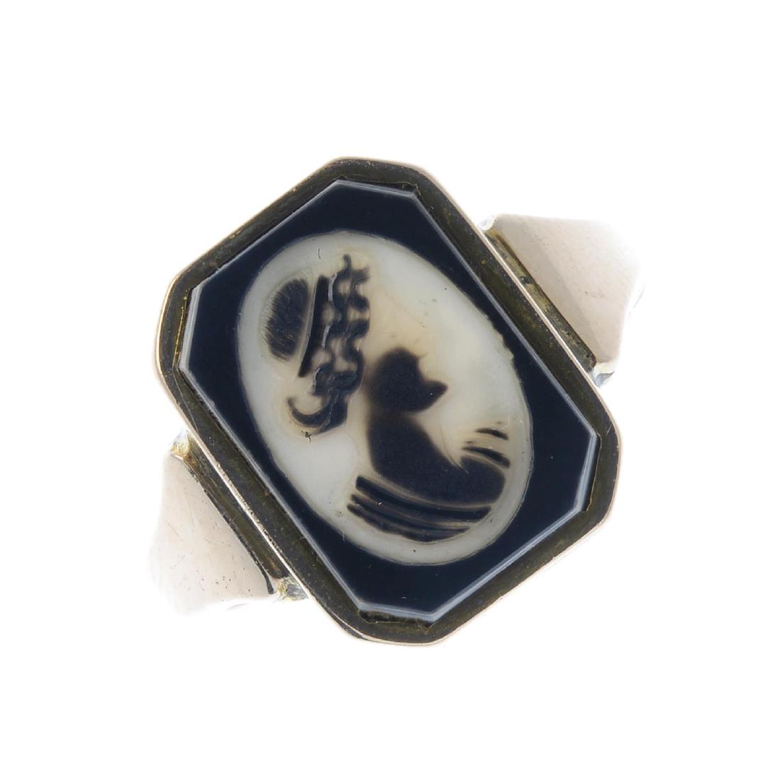 A mid 20th century onyx cameo signet ring. Designed as (1 of 3)