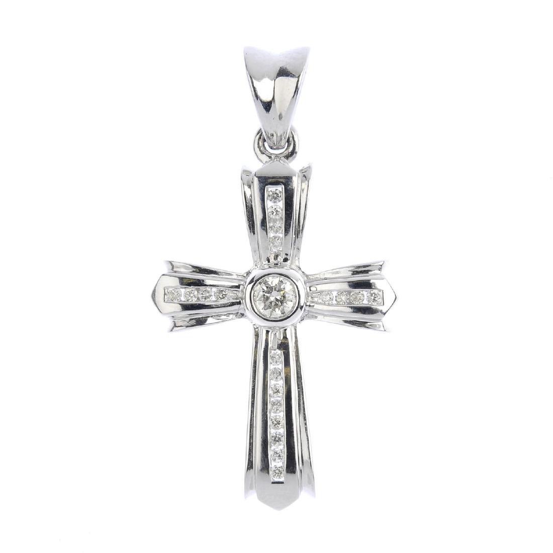 A 9ct gold diamond cross pendant. The brilliant-cut (1 of 3)